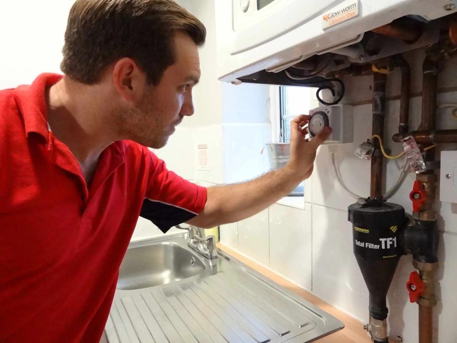 Pinner Plumbers 247 boiler repair engineer working on a boiler in Pinner